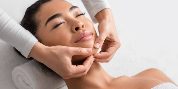 Face Lifting Massage. Young Korean Woman Getting Beauty Treatments By Professional Masseur At Cosmetology Cabinet, Relaxed Asian Female Enjoying Wellness Day At Spa Salon, Closeup Shot